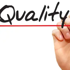 Hand schreibt "Quality" mit rotem Stift. Call monitoring für höchste Qualität.